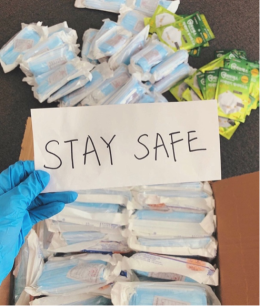 Sign says "Stay Safe" with protective masks