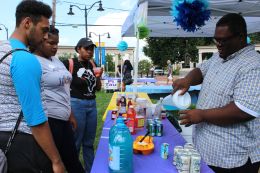 Austin Duckett serves drinks at the Involvement Fair