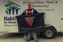 Student Aidan Looby holding a flag