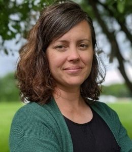 Headshot of Diane Sanders wearing green sweater and black shirt