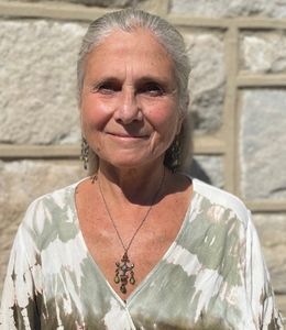 Head and shoulders shot of Dr. Nadine McHenry in front of stone wall