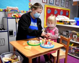 An occupational therapy students works on exercise with a young student.