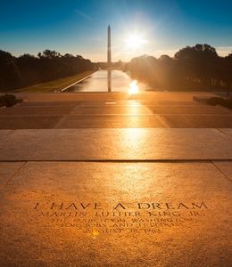 Photo shows MLK's "I have a dream quote" carved onto the floor of the Lincoln Memorial overlooking the Washington Monument at sunrise.