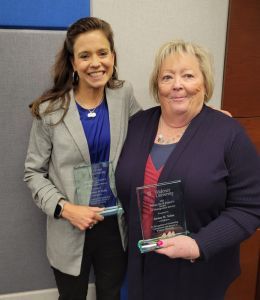 Courtney Kelly and Jeanne Nolan standing together holding their Eckard Awards
