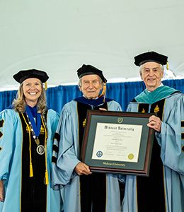 President Robertson, Dr. Scheer, and Paul Beideman posing with the honorary degree.