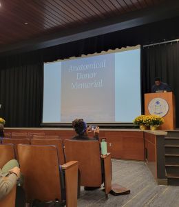 Alumni Auditorium stage with screen that says Anatomical Donor Memorial