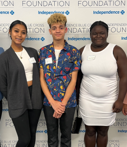 recipients of the award pose in front of an Independence Blue Cross background 
