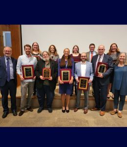 A group photo of the faculty holding their awards. 