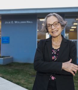 Julie E. Wollman poses in front the renamed Wollman Hall on Widener's campus.