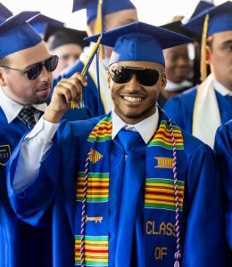 Happy graduates smiling in caps and gowns