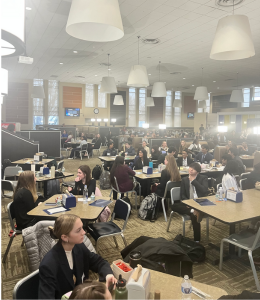 A photo overlooking the pride cafe with tables full of students socializing