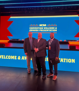 Jack Shafer and two other men pose in front of a screen that reads "NCAA Convention Welcome and Awards Presentation"