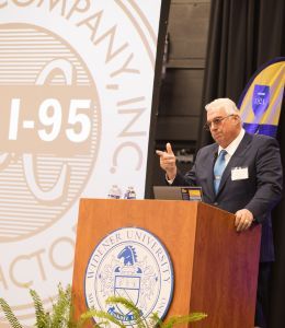 Robert Buckley presents at a podium.