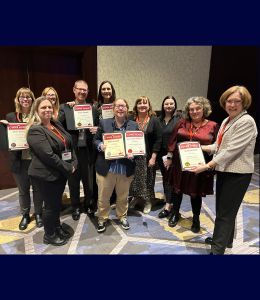 The University Relations team poses with their awards.