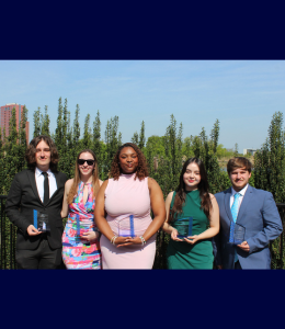 Five student leaders pose holding awards