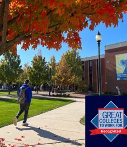Student walking on campus in autumn with the Great Colleges to Work For logo in the bottom corner
