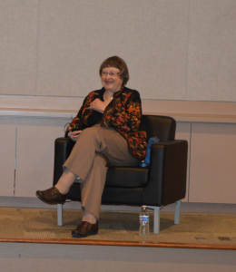 Mary Beth Norton sits in a chair, smiling.