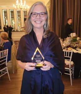 President Stacey Robertson holding her most admired ceo award