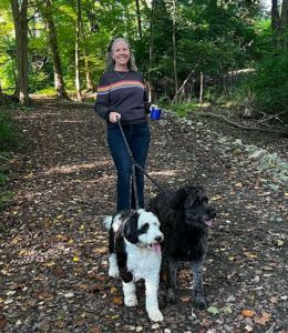 Stacey Robertson casuals walks with her two dogs on a nature trail.