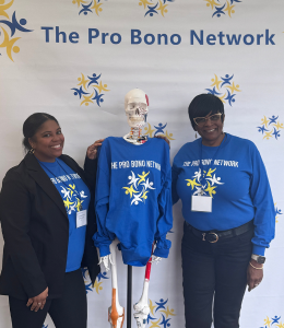 Two students pause with a skeleton model