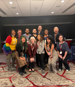 Widener students, faculty and alumni pose for a photo at a conference