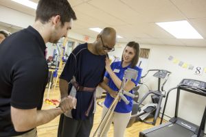physical therapy students and client in clinic