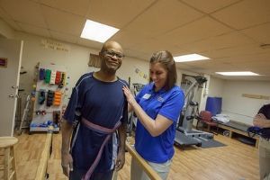 PT student in clinic with client