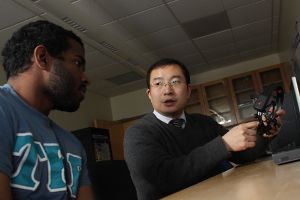 Robotics Faculty 300x200 Robotics engineering professor advising a student on pathways in the robotics program.