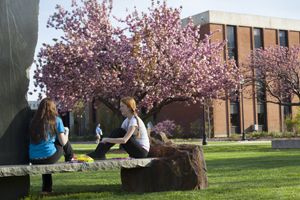 Students Sitting on Marble Bench
