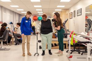 Physical therapy students working with a client