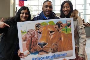 Students hold Choose Widener sign