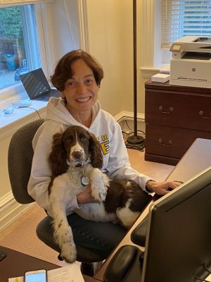 President Wollman works at home with her dog