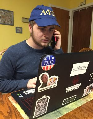 Matthew Lomas, APO president, working at his laptop and on the phone 