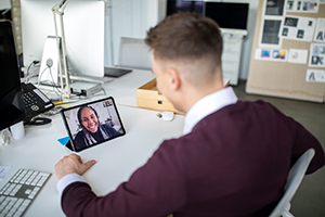 Student learning online 300x200 Adult student virtually meeting with a professor on a tablet