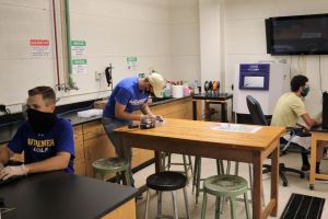 Graduate and undergraduate students in the lab investigating ways to improve 3D printing