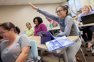 Adult/accelerated nursing student raising hand in class 300x200 Adult nursing student raising hand in class