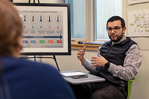 Lenin Agudo in SBDC/Small Business Development Center Professional sitting in Small Business Development Center working with client