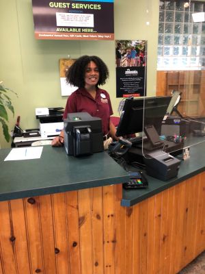 Donya Moore stands behind a guest services desk at Hershey Park