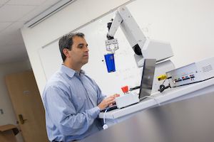 robotics engineering faculty demonstrates robotics arm equipment. Widener's School of Engineering is considered one of the top schools for engineering; offering degrees across many engineering fields.