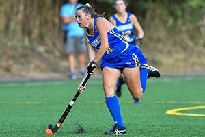 Field hockey player dribbling (athletics) 300x200 Widener field hockey player dribbling on turf field