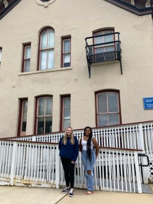 Two students stand outside of Old Main Annex on civil rights walking tour. 