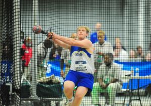 Athlete Alex Kristeller throwing weight at NCAA competition
