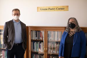 Adam Mizelle Jessica Guzman pose side-by-side in the Greene Poetry Room