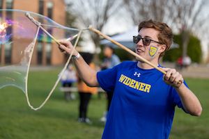 Student playing with bubbles on Founder's Day