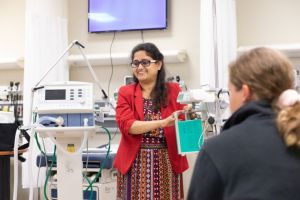 Ria Mazumder works with her biomedical engineering students in the nursing sim lab