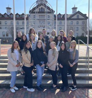 Students in the speech language pathology program pose in front of Old Main as first-year students.