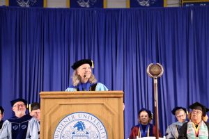 President Robertson stands at the podium addressing the crowd