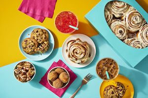 A collection of items from Cinnabon, including cinnamon rolls and drinks