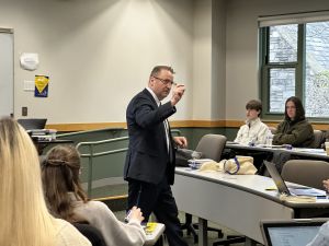 Dean andré douglas pond cummings emphasizes a point during a lecture to students. 