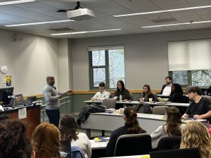 Dean Todd Clark calls on students in a classroom during a lecture. Clark points at a student to draw attention.